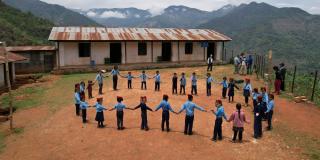Children hold hands in circle