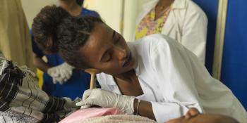 Doctor Tsigemariam Bekalu listens to a baby's heartbeat pre-delivery
