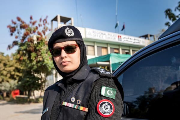 A female police officer stands in front of the regional police office