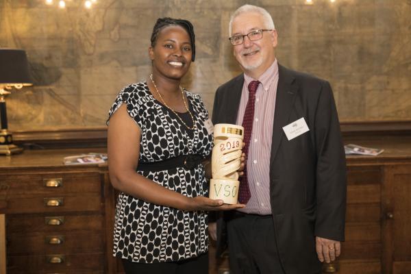 Ann Wambu holds her 2019 Education Award and stands with Dave Kitchen of NASUWT