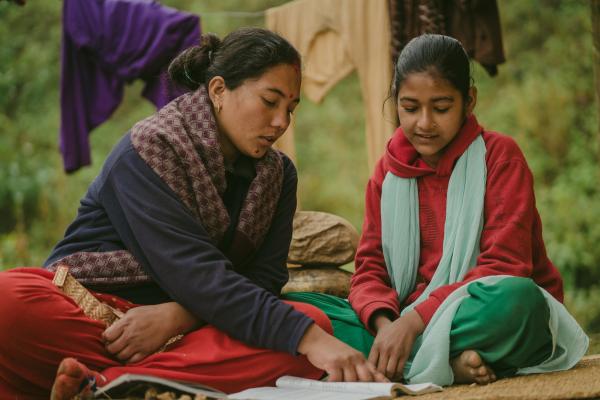 Big Sister Rama helps her Little Sister Pramila to study
