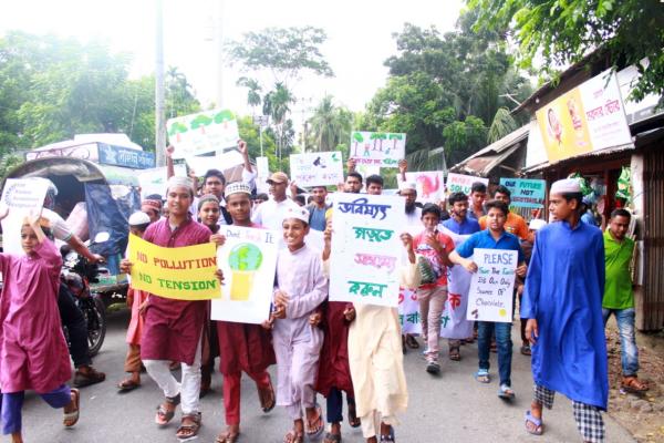 Young people hold placards as they march in the street in Bangladesh