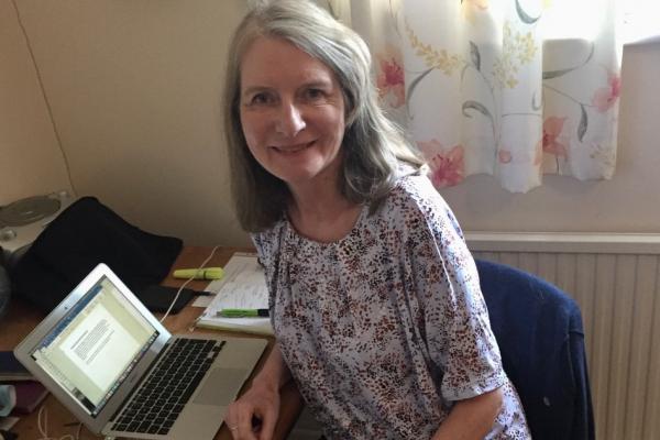 Gail Aldwin working at her laptop from her spare room.