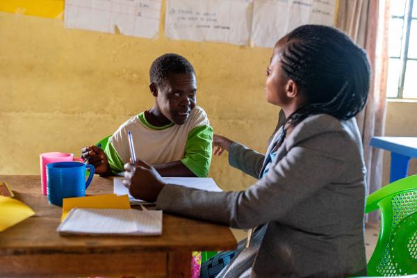 Clemenia* with her teacher Rael in a VSO-run catch up centre in Migori county, Kenya