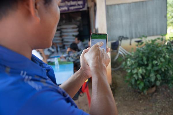 A lead farmer on the Improving Market Access for the Poor project uses a mobile phone app