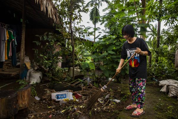 Mi Moe Khaing sweeps at her home in Mon state, Myanmar.