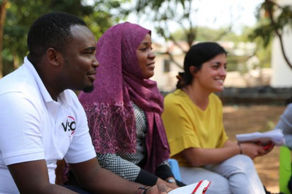 VSO national volunteers Ally Nguba and Asha Hamis sit with Randstad volunteer Veronica Conti as they carry out an aspirations analysis session