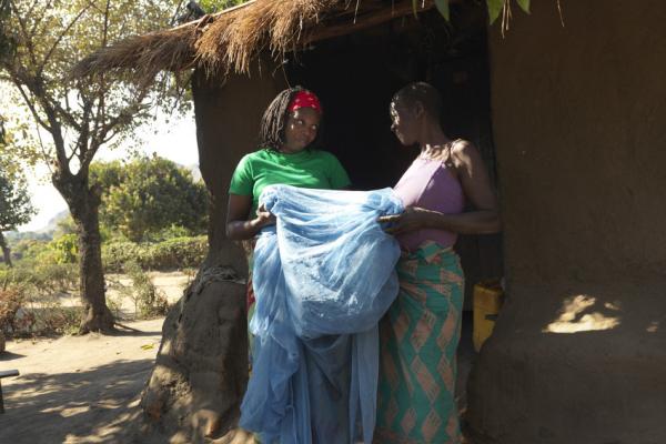 Community volunteer Luisa Jose visits Ana Noris to advocate malaria prevention by using Mosquito nets after cyclone Idai.