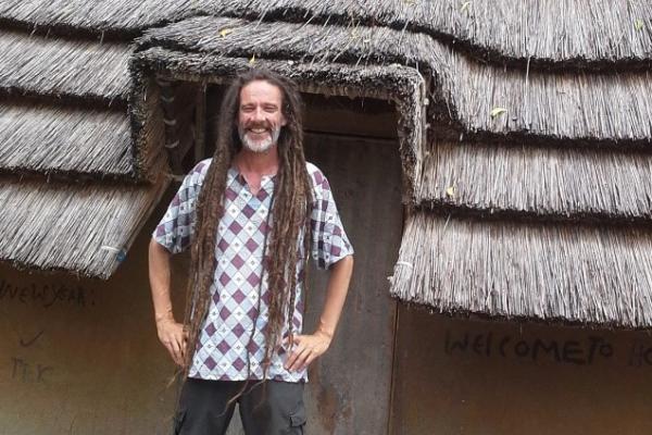 man stood outside a hut in south sudan