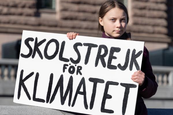 Climate activist Greta Thunberg holding a sign for the school climate strike.