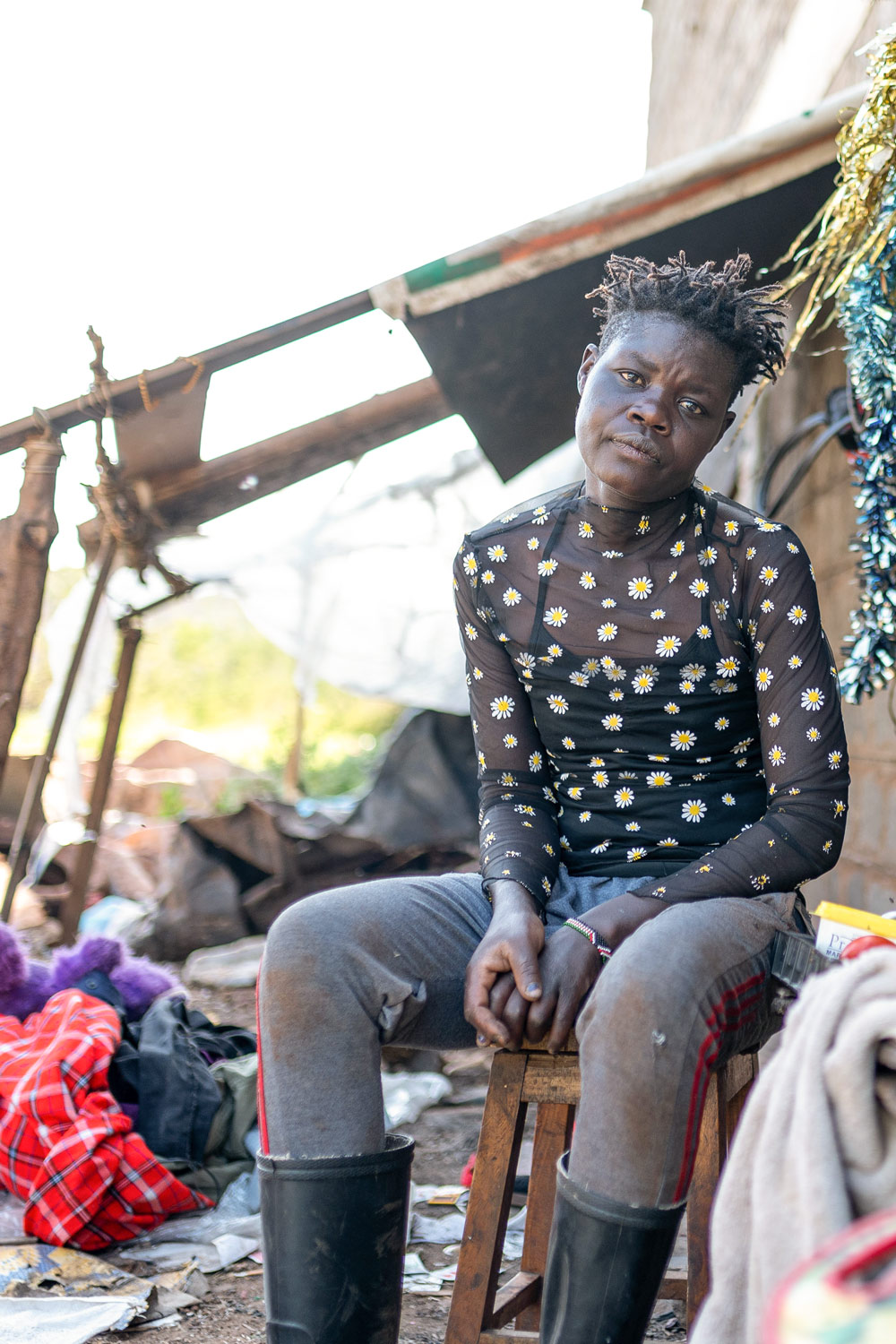 Pauline, outside her home in Kibera