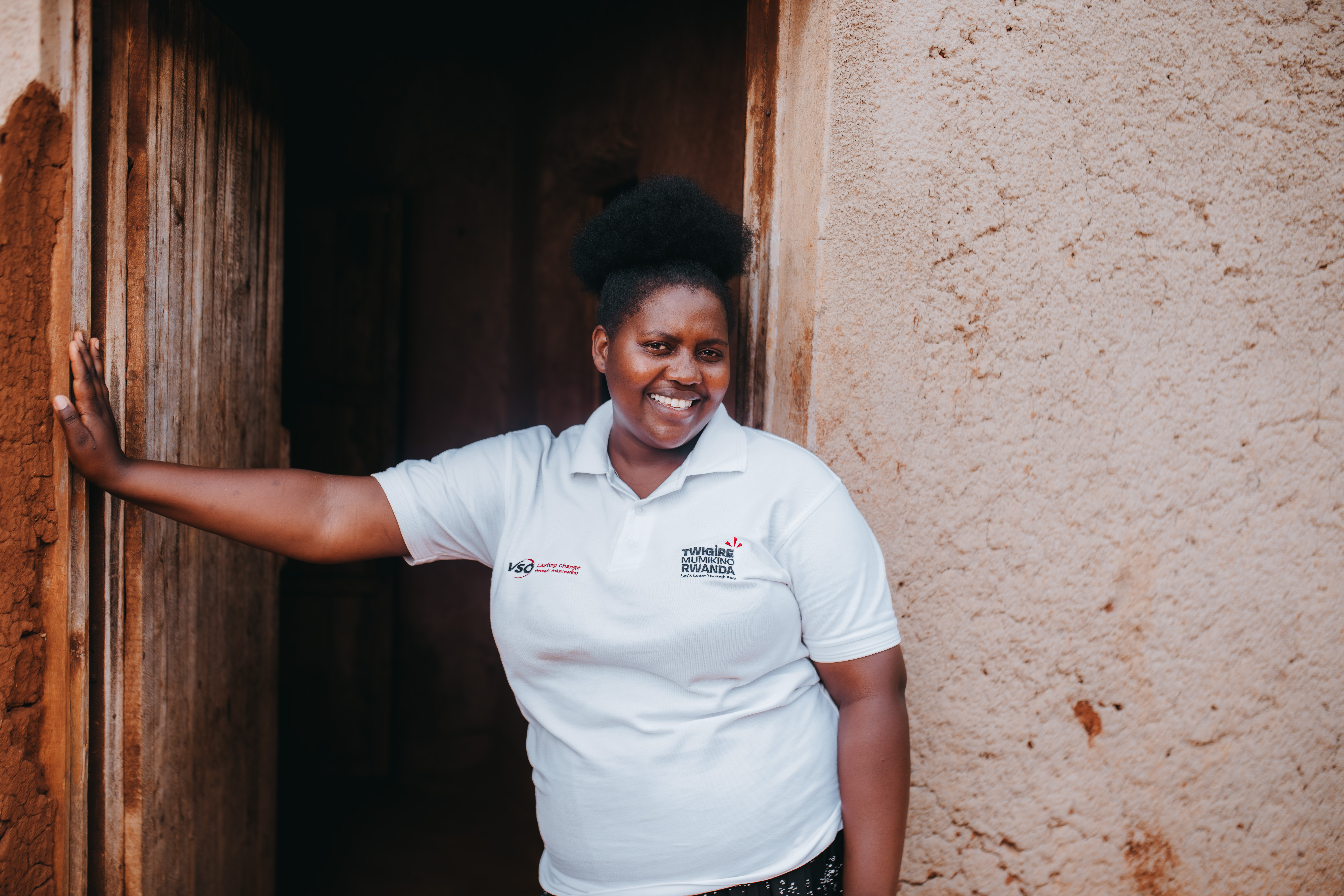 Volunteer Diane stands outside a primary actor's home