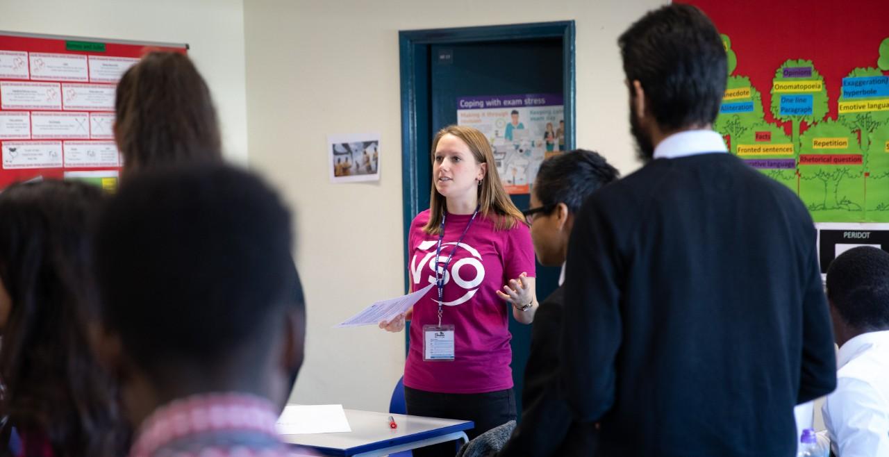 Ellie gives a talk in a school about VSO's work across the globe