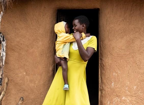 Consolata at home with her child