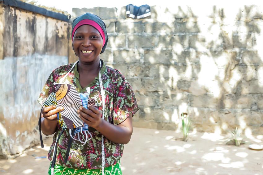 Mumagkur, a Nigerian seamstress, who now sews protective face coverings.