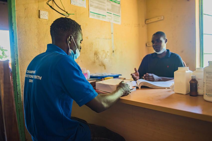 Community volunteer collecting contraceptives to distribute