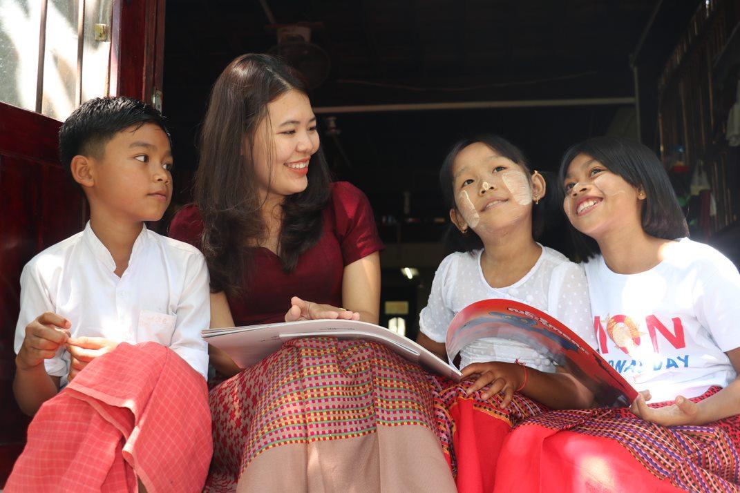 Khine reads to school children