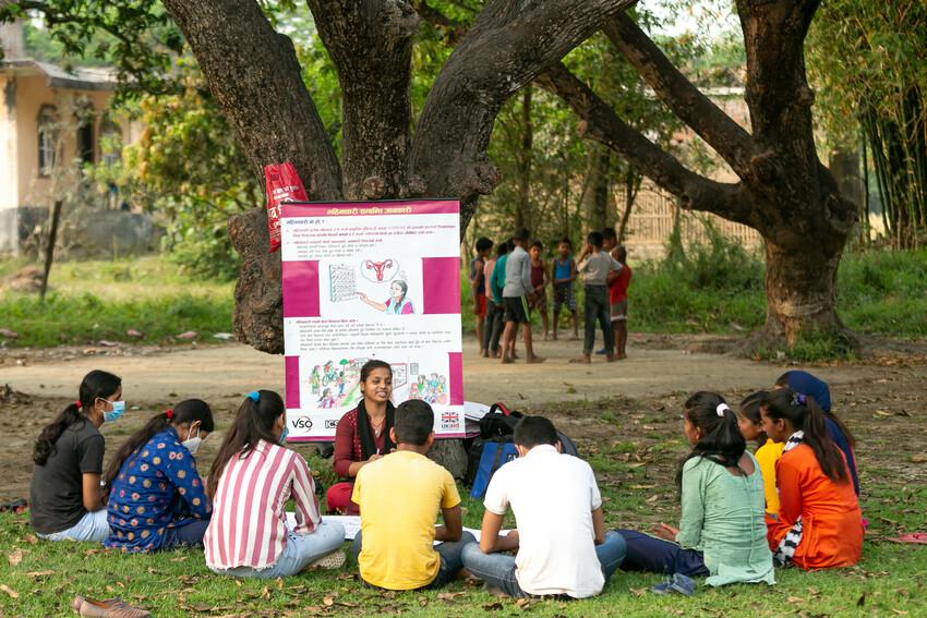 Youth Health Champion Manisha gives a demonstration on sanitary pads