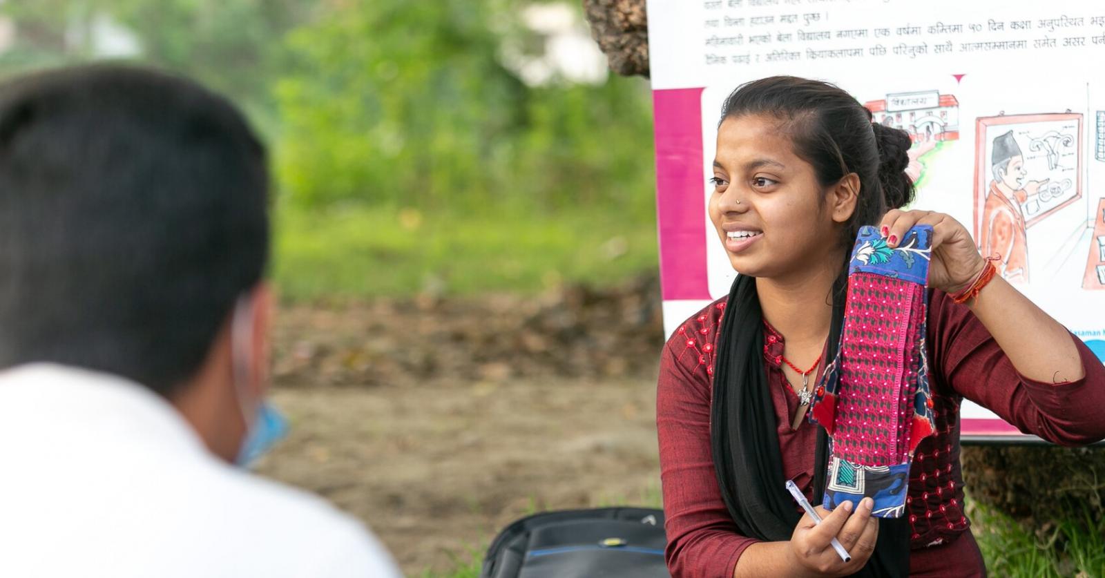 Volunteer Manisha discussing the use of cotton and sanitary pads