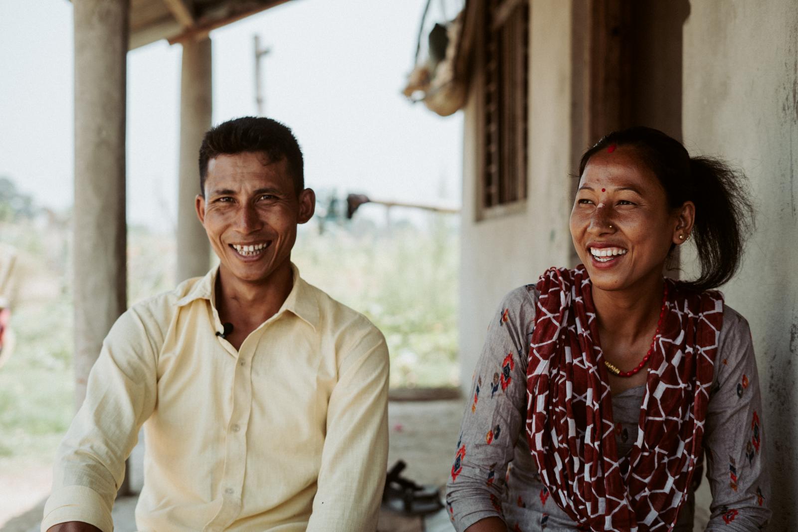 Couple smiling at camera.