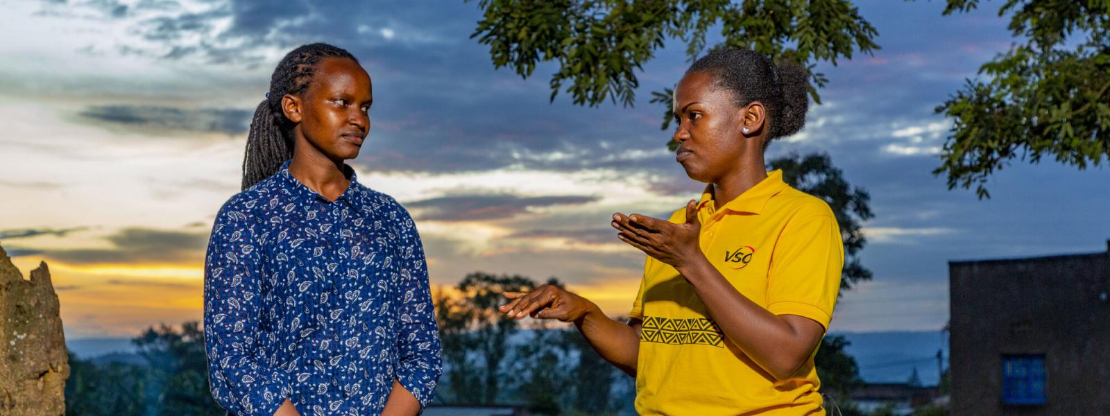 Brown, a VSO deaf volunteer discussing with Joy, a sign language interpreter