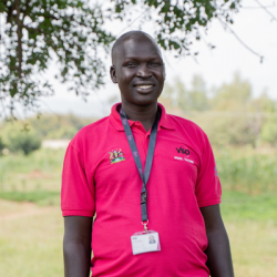 VSO volunteer Alfred, smiling at the camera.