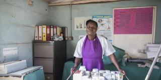 A nurse stands in the Chikurubi prison clinic with a trolley of medicines in front of her