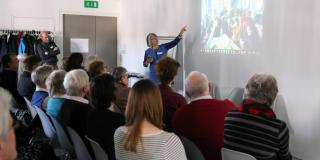 A returned volunteer gives a presentation about her VSO professional volunteering placement