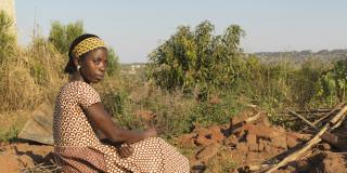 Community volunteer Gracinda Gonclaves by a destroyed home after Cyclone Idai.
