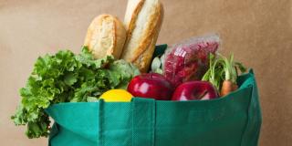 A reusable bag filled with fresh healthy veg