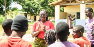 Volunteer Monica Atim talks to a group of peer educators she's trained