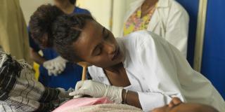 Doctor Tsigemariam Bekalu listens to a baby's heartbeat pre-delivery