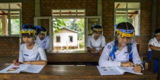Girls study after going back to school in Myanmar.