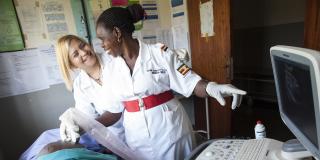 A VSO volunteer training midwife on clinical ultrasound