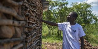 Community volunteer Socrates visits a rebuilt home