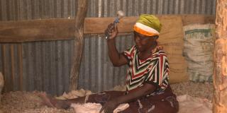 Woman miner crushing stones