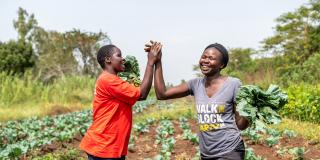 Female farmers high-fiving