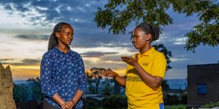 Brown, a VSO deaf volunteer discussing with Joy, a sign language interpreter