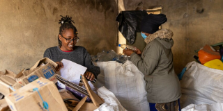 Two women sorting waste for recycling