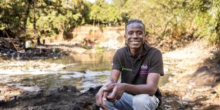 Lawrence, community volunteer by polluted river in Nairobi