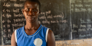 Juliet stands in her classroom