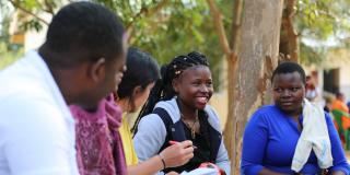 VSO national volunteer Jackline Kakala smiles as she conducts an aspirations analysis with young women participating in the Lake Zone Youth Empowerment project