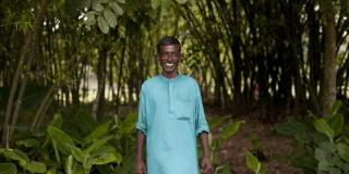 Abdul Latif, pictured here standing outdoors, is a farmer working with VSO on the Growing Together project.