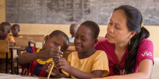 7-year-old Blessing Asokiyine (centre) with her 6-year-old classmate Klevin Atinga and VSO volunteer Mary Carnable, at Goriko kindergarten in Talensi District, Bolgatanga, Ghana