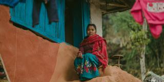 Devna* sits on the steps of her husband's home Young wife in Nepal