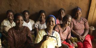 Women hold up solar lanterns in Malawi