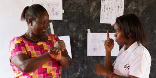 Brown Niyonsaba is signing to explain her work educating young deaf people on sexual and reproductive health issues Brown Niyonsaba is signing to explain her work educating young deaf people on sexual and reproductive health issues