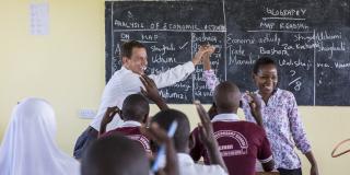 Volunteer Paul teaching a class with teacher-mentor Rebecca