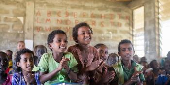 VSO assists the Ethiopian government with improving education in the underdeveloped Benishangul-Gumuz region. Ethiopian children sat in a class, smiling and clapping their hands