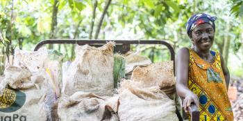 A farmer standing next to their harvested crops
